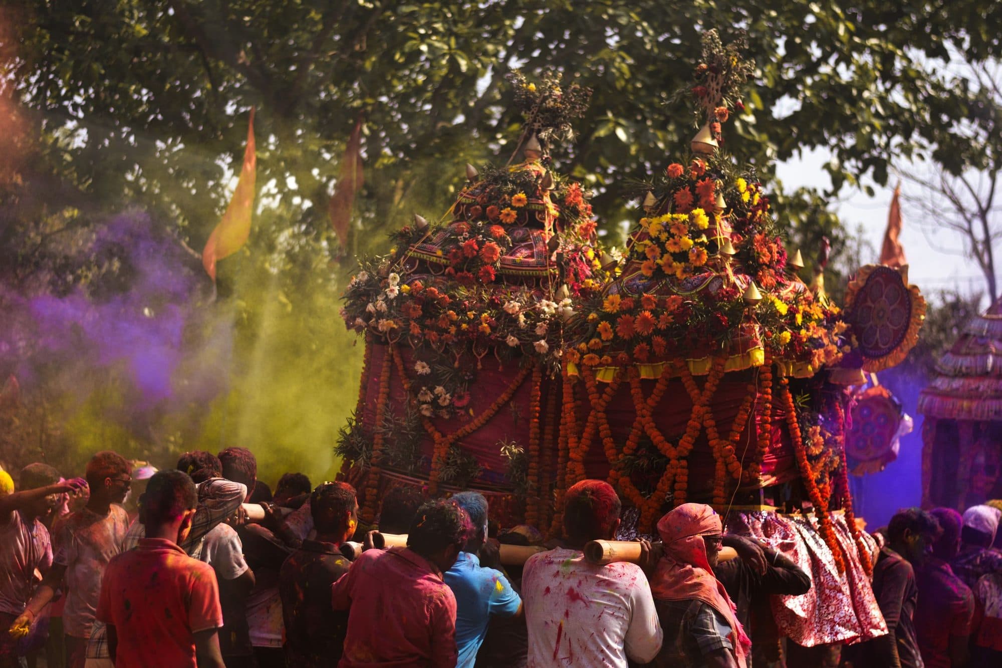 A Holi procession under clouds of coloured powder